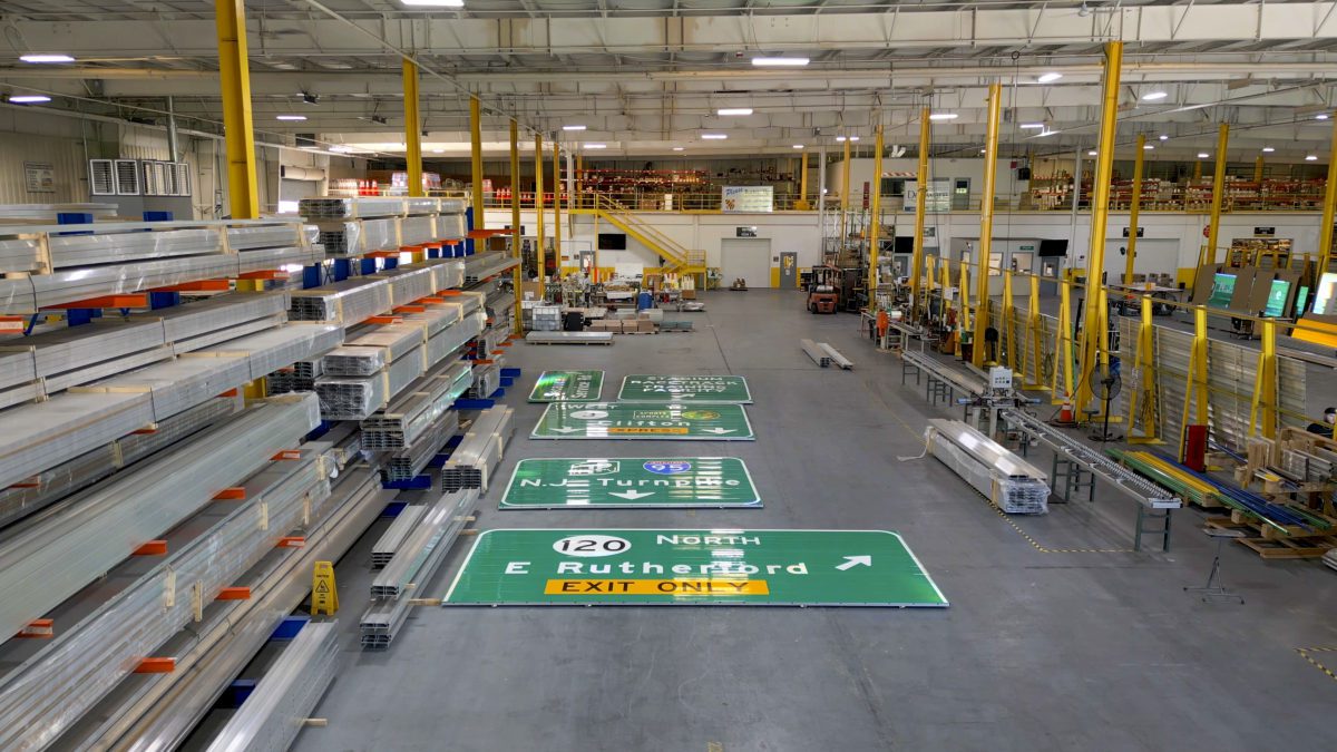 Finished highway guide signs laid out on the National Highway Products shop floor